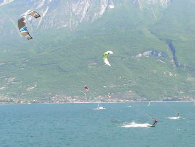 Kite surfing with Malcesine in the background Kite surfing with Malcesine in the background